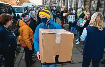 Wolontariusze segregują dary z pomocą dla uchodźców z Ukrainy. Edynburg, Szkocja, 6 marca 2022 r. / Jeff J Mitchell / Getty Images