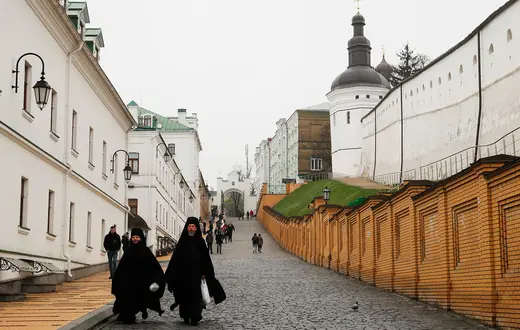 Duchowni Ukraińskiej Cerkwi Prawosławnej Patriarchatu Moskiewskiej na tle zabudowań Ławry Peczerskiej, przekazanej przez rząd Ukrainy, z końcem 2022 r., pod całkowity zarząd Prawosławnej Cerkwi Ukrainy, Kijów, kwiecień 2023 r. // Fot. Sergy Dolzhenko / PAP