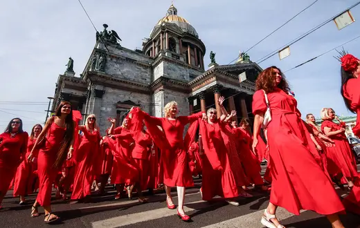 "Projekt w czerwonej sukience" -- flash mob kobiet popierających inicjatywę prezydneta Putina ogłoszenia Roku Rodziny Federacji Rosyjskiej, Peterburg, czerwiec 2024 r. // Fot. Artem Priakhin / SOPA Images/ Getty Images