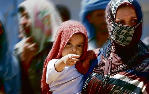 Uciekinierzy z Mosulu w obozie Aski Kalak, 40 km na zachód od miasta Irbil, stolicy kurdyjskiego regionu autonomicznego. 17 lipca 2014 r. / Fot. Safin Haned / AFP / EAST NEWS