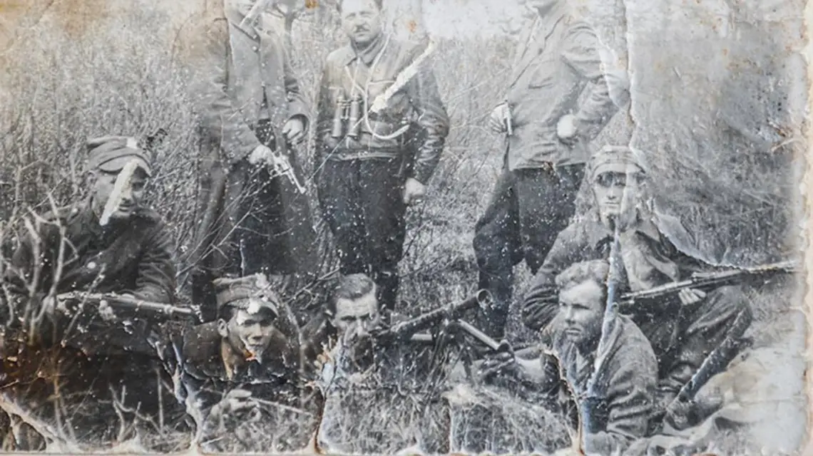 Drużyna z oddziału AK „Marcina” w lasach pod Włoszczową, jesień 1944 r. 15-letni Andrzej Sikorski leży pierwszy z lewej. / Fot. Zbiory Andrzeja Sikorskiego