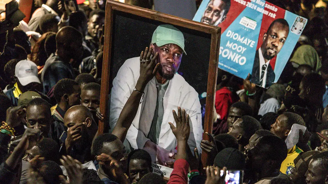 Zwolennicy senegalskiej opozycji z portretami i plakatami swych liderów: Bassirou „Diomaye” Faye i Ousmane Sonko świętują ich zwolnienie z więzienia. Dakar, 14 marca 2024 r. // John Wessels / AFP / East News
