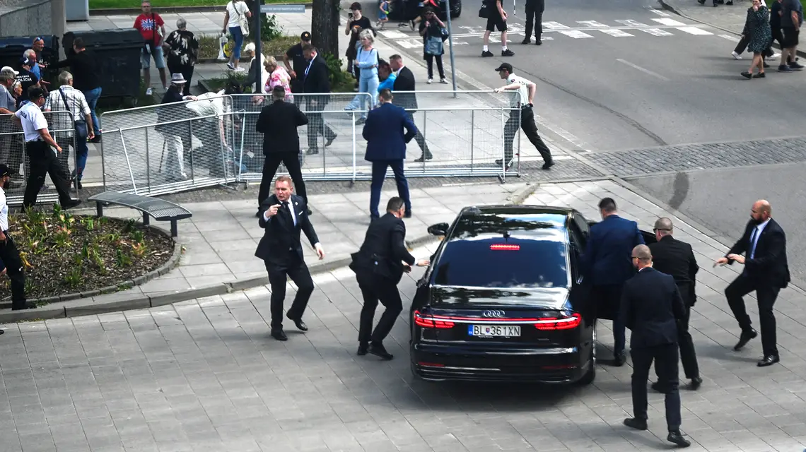 Oficerowie ochrony ewakuują słowackiego premiera Roberta Ficę z miejsca, w którym doszło do zamachu. Handlova, 15 maja 2024 r. // Fot. Radovan Stoklasa / Reuters / Forum