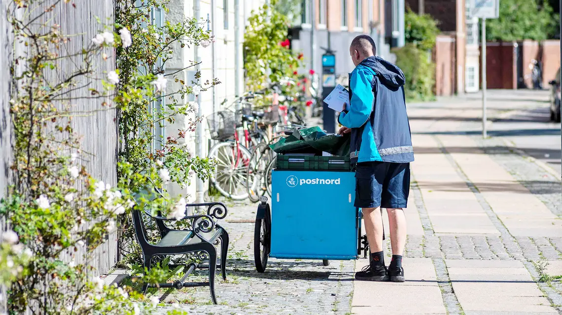 Listonosz duńskiej poczty PostNord na ulicy Kopenhagi. Dania, 31 sierpnia 2020 r. // Fot. Christian Lindgren / AFP / East News