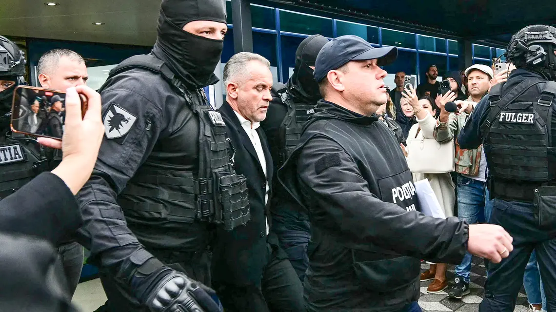 Vlad Plahotniuc (w środku) wraca z Grecji do Mołdawii w kajdankach. Lotnisko w Kiszyniowie, 25 września 2025 r. // Fot. Daniel Mihailescu / AFP / East News