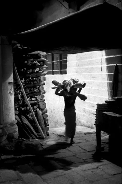 Środek nocy. Jeden z Domów pracujących na Manikarnika ghat niesie drewno, aby ułożyć stos nad brzegiem Gangesu /fot. Wojciech Nowicki/visavis.pl / 
