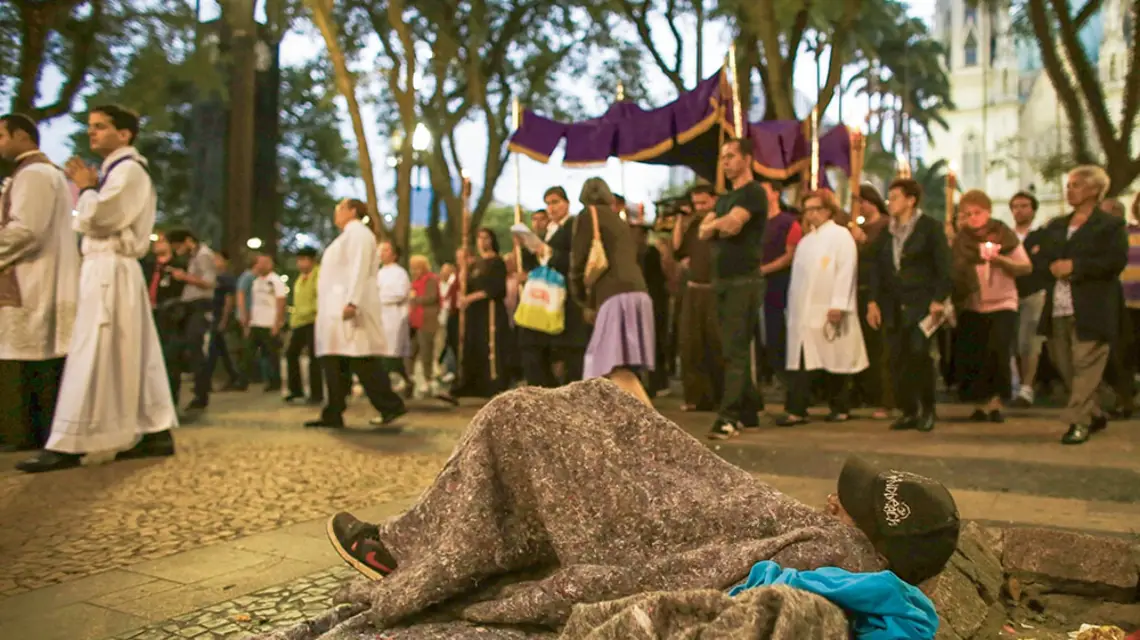 Uczestnicy procesji w Wielki Piątek mijają bezdomnego, São Paulo (Brazylia), marzec 2013 r. / NACHO DOCE / REUTERS / FORUM