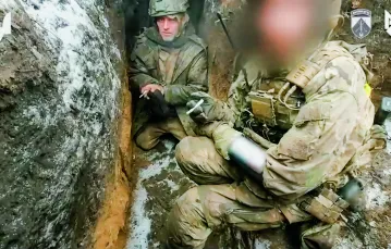 Jeniec z armii rosyjskiej (z lewej), który twierdzi, że jego „pradziadek był Polakiem”, i że chciałby „wyjechać do Polski”. Z prawej żołnierz ukraiński (z zakrytą twarzą). Kadr z filmu opublikowanego 8 lutego 2024 r. przez ukraińskie Siły Operacji Specjalnych. / Telegram: t.me/ukr_sof