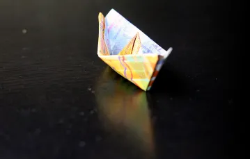 Banknot dziesięciofrankowy złożony w łódkę origami