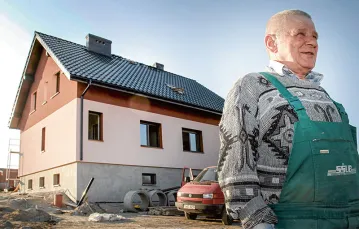 Mieszkańcy ustalili, że w nowej wsi domy będą wyglądały podobnie: białe ściany i czarny dach / Fot. Grzegorz Celejewski / AGENCJA GAZETA