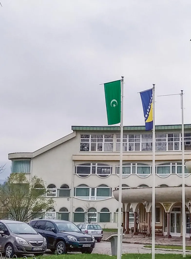 Flaga Bośni oraz półksiężyc z gwiazdą na zielonym tle, symbole islamu, przed Wydziałem Pedagogiki Islamskiej w Bihaciu, sfinansowa- nym przez Arabię Saudyjską. Maj 2019 r. / FOT. DARIUSZ KAŁAN